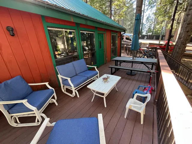 a view of a couches in the patio next to a yard