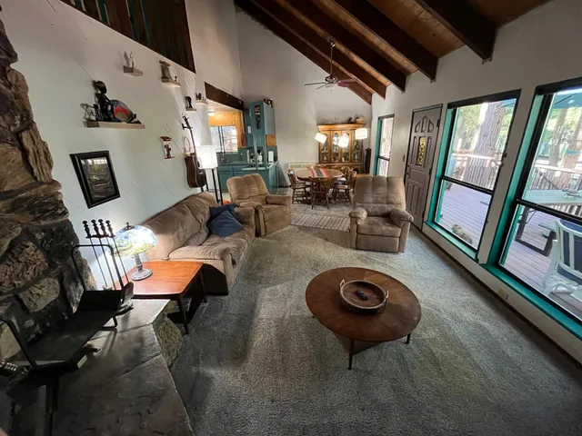a view of a livingroom with furniture hardwood floor and a large window