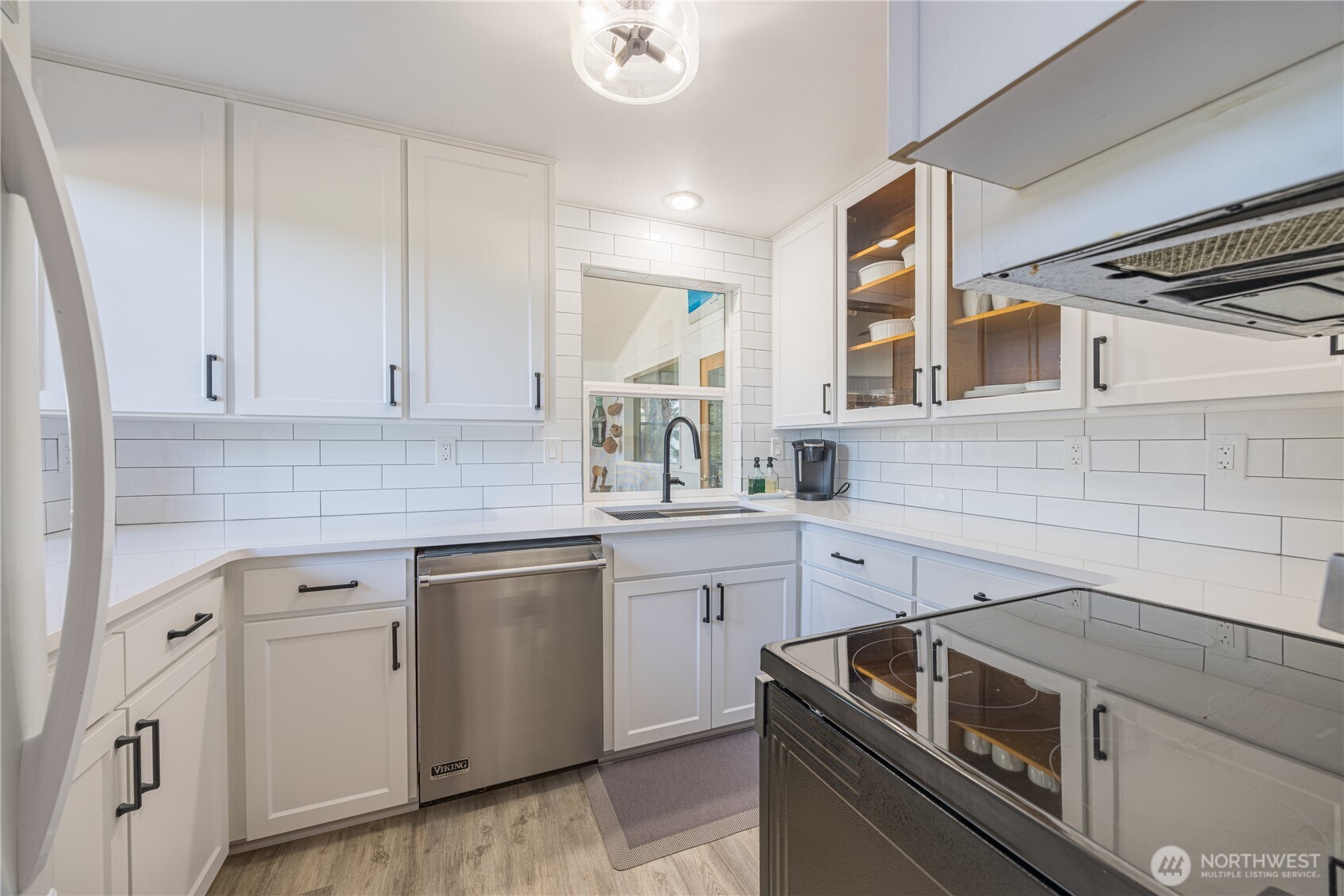 382 Discovery Way Sequim, WA 98382 - Photo 21 of 40 a kitchen with white cabinets and white appliances