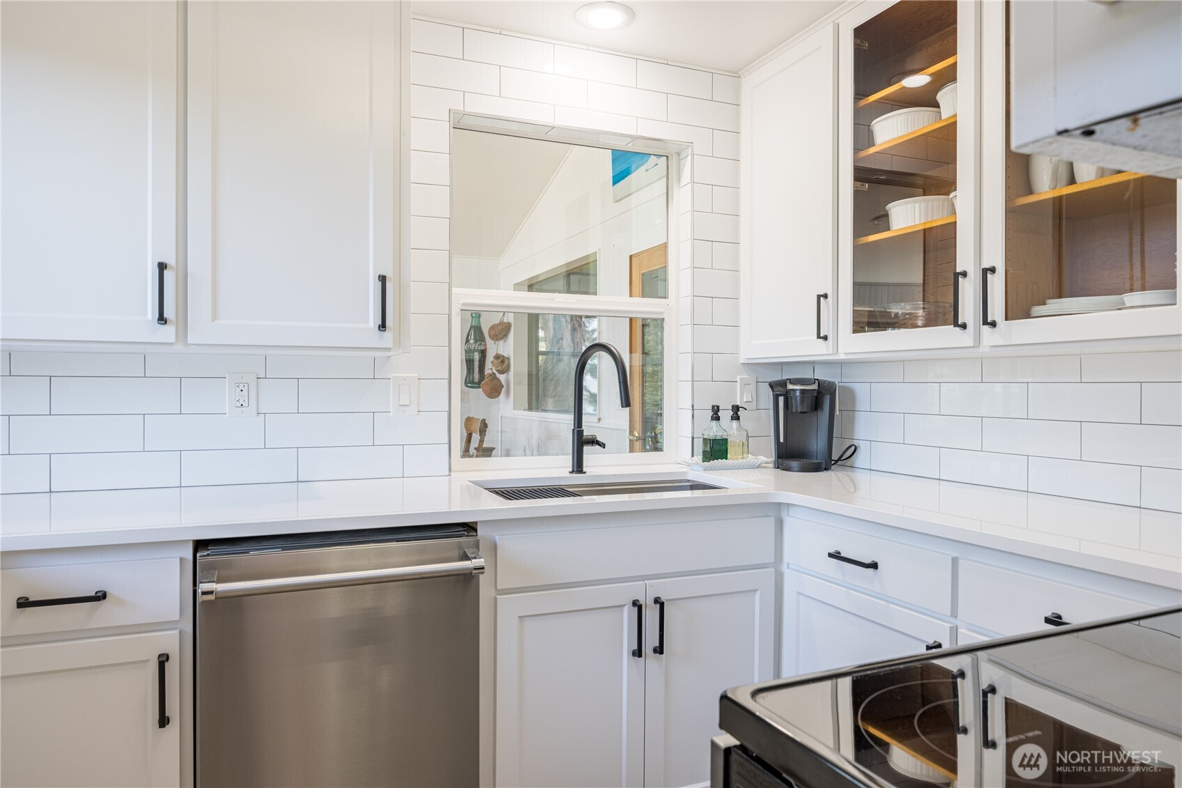 382 Discovery Way Sequim, WA 98382 - Photo 22 of 40 a kitchen with a sink and cabinets