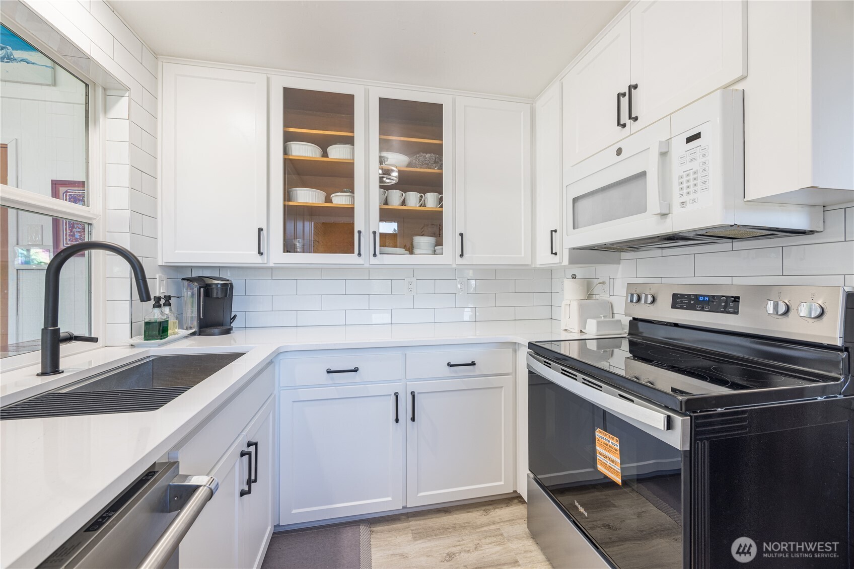 382 Discovery Way Sequim, WA 98382 - Photo 23 of 40 a kitchen with granite countertop a stove sink and cabinets