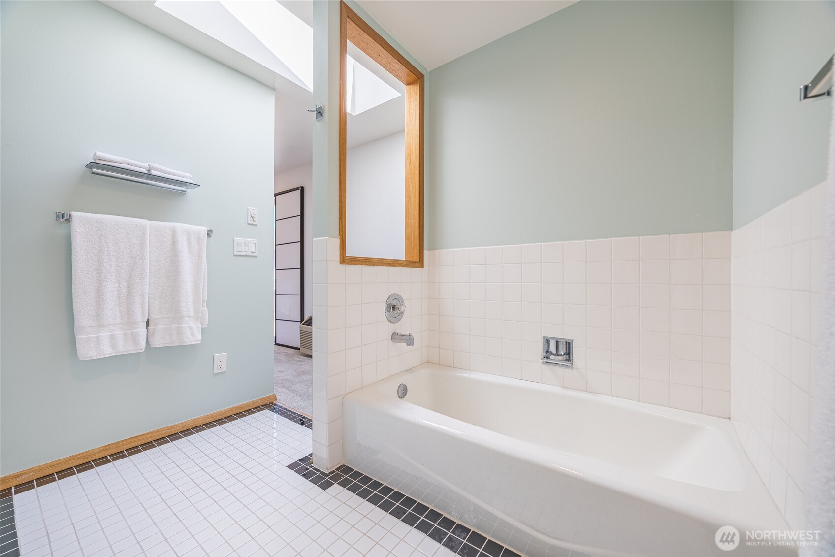 382 Discovery Way Sequim, WA 98382 - Photo 31 of 40 a white bath tub sitting next to a white sink and a mirror