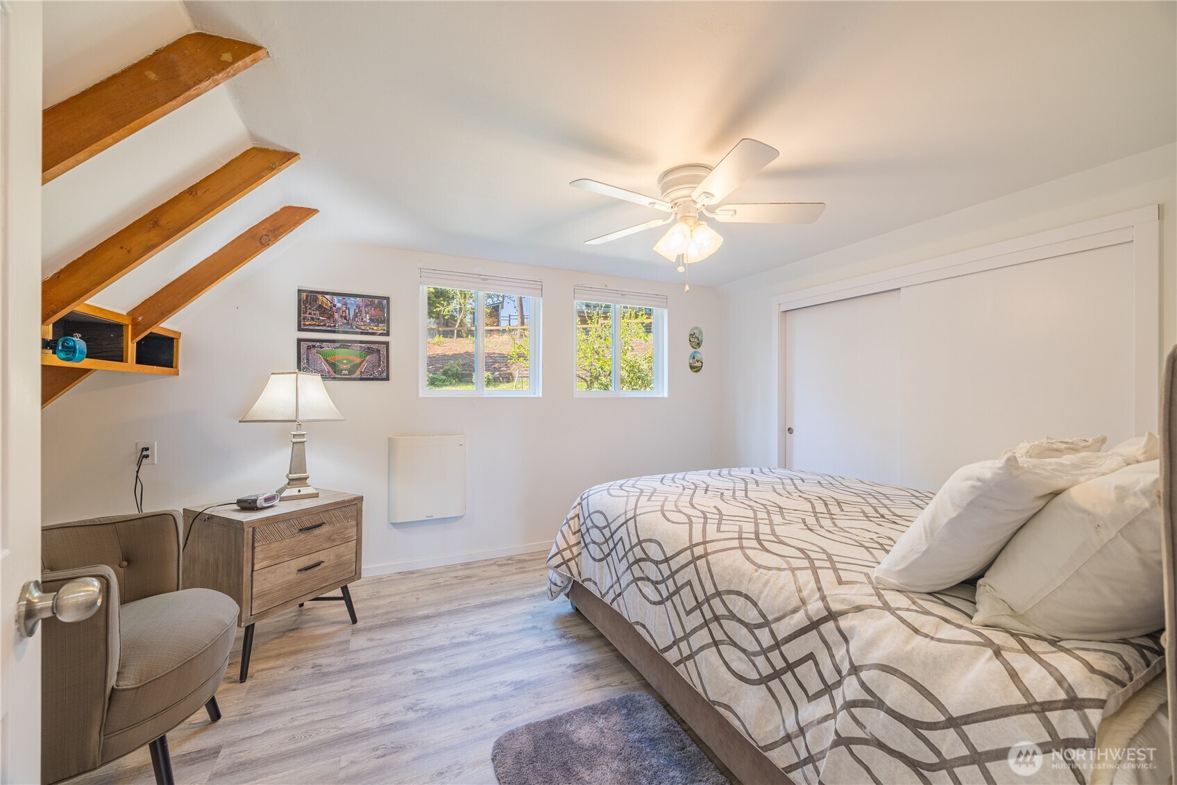 382 Discovery Way Sequim, WA 98382 - Photo 32 of 40 a bedroom with a bed and a chandelier