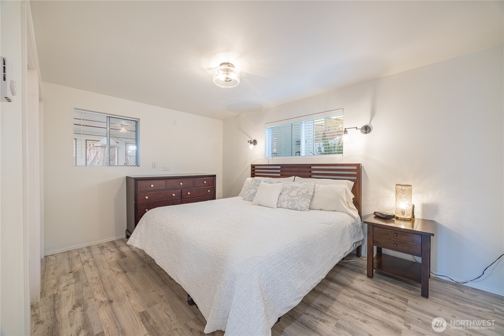 382 Discovery Way Sequim, WA 98382 - Photo 34 of 40 a bedroom with a bed and wooden floor