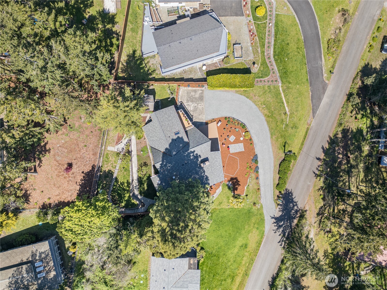 382 Discovery Way Sequim, WA 98382 - Photo 7 of 40 an aerial view of a house with outdoor space swimming pool and lake view