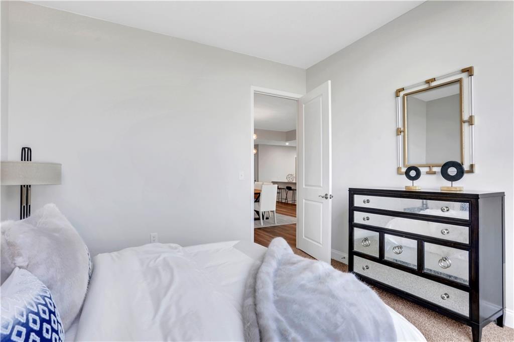 270 17th Street Northwest, Unit 3308 Atlanta, GA 30363 - Photo 17 of 49 a bedroom with a bed dresser and a window