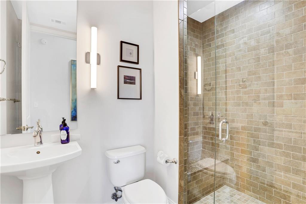 270 17th Street Northwest, Unit 3308 Atlanta, GA 30363 - Photo 18 of 49 a bathroom with a toilet sink and shower