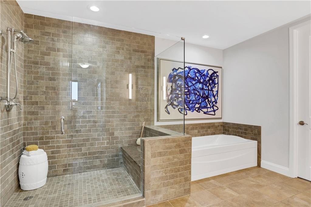 270 17th Street Northwest, Unit 3308 Atlanta, GA 30363 - Photo 23 of 49 a bathroom with a bathtub and shower