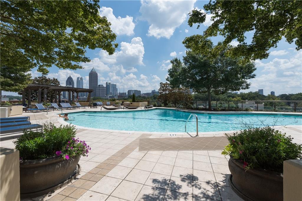 270 17th Street Northwest, Unit 3308 Atlanta, GA 30363 - Photo 30 of 49 a swimming pool with outdoor seating and plants