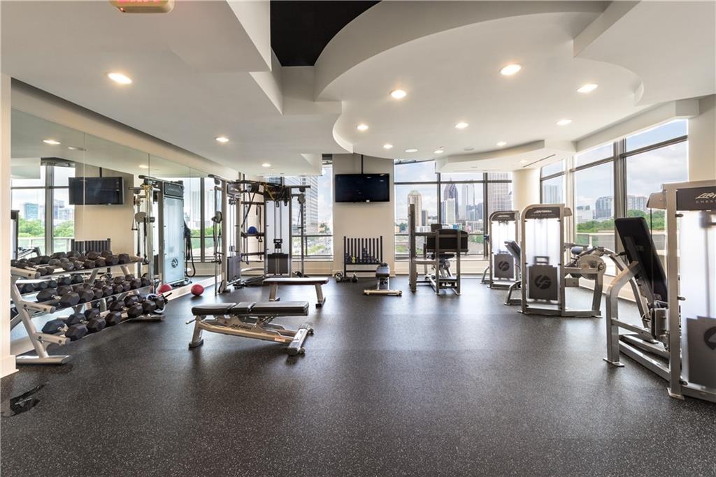 270 17th Street Northwest, Unit 3308 Atlanta, GA 30363 - Photo 43 of 49 a view of a room with gym equipment and a large window