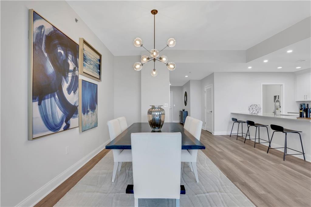 270 17th Street Northwest, Unit 3308 Atlanta, GA 30363 - Photo 10 of 49 a living room with furniture and a chandelier