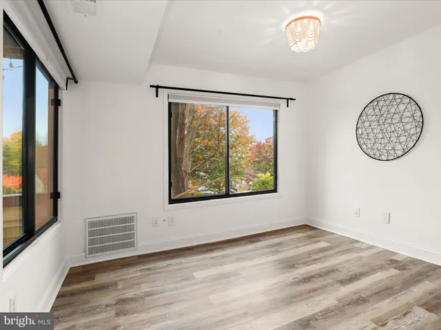 a view of room with window and wooden floor