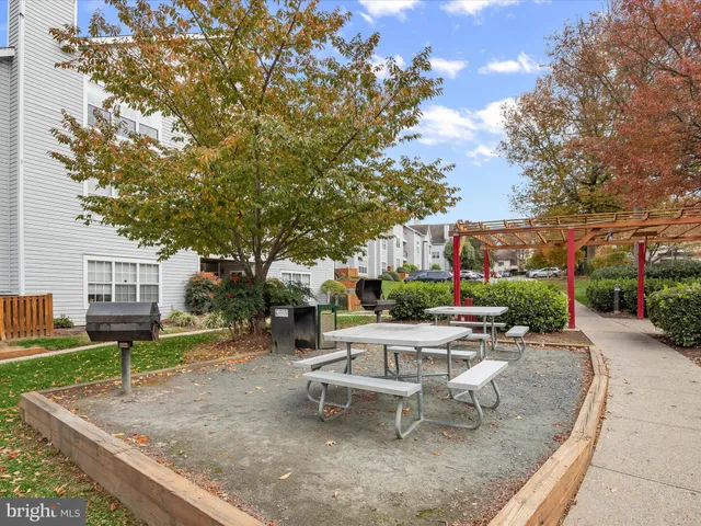 a backyard with plants and outdoor seating