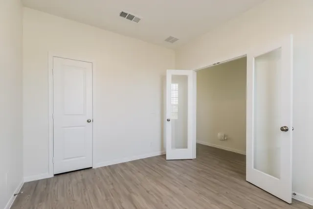 a view of an empty room and wooden floor