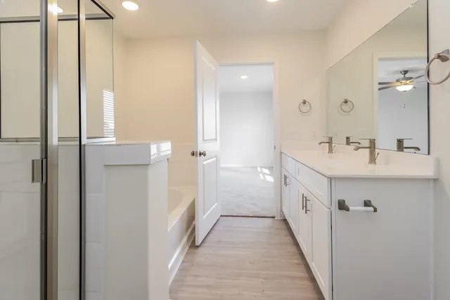 a bathroom with double vanity and a mirror