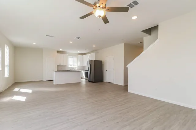 a view of a kitchen with a sink and a ceiling fan