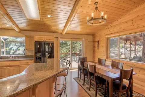 a view of a dining room with furniture large windows and wooden floor