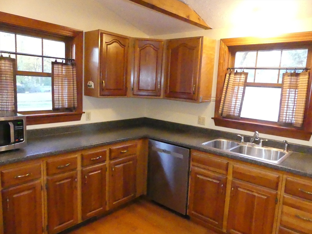 52 Ellsworth Avenue Beverly, MA 01915 - Photo 7 of 24 a kitchen with wooden cabinets and sink