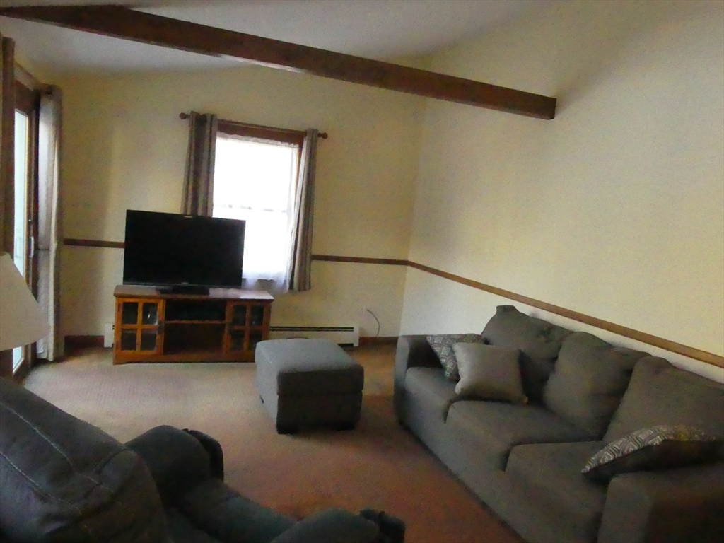 52 Ellsworth Avenue Beverly, MA 01915 - Photo 8 of 24 a living room with furniture and a flat screen tv