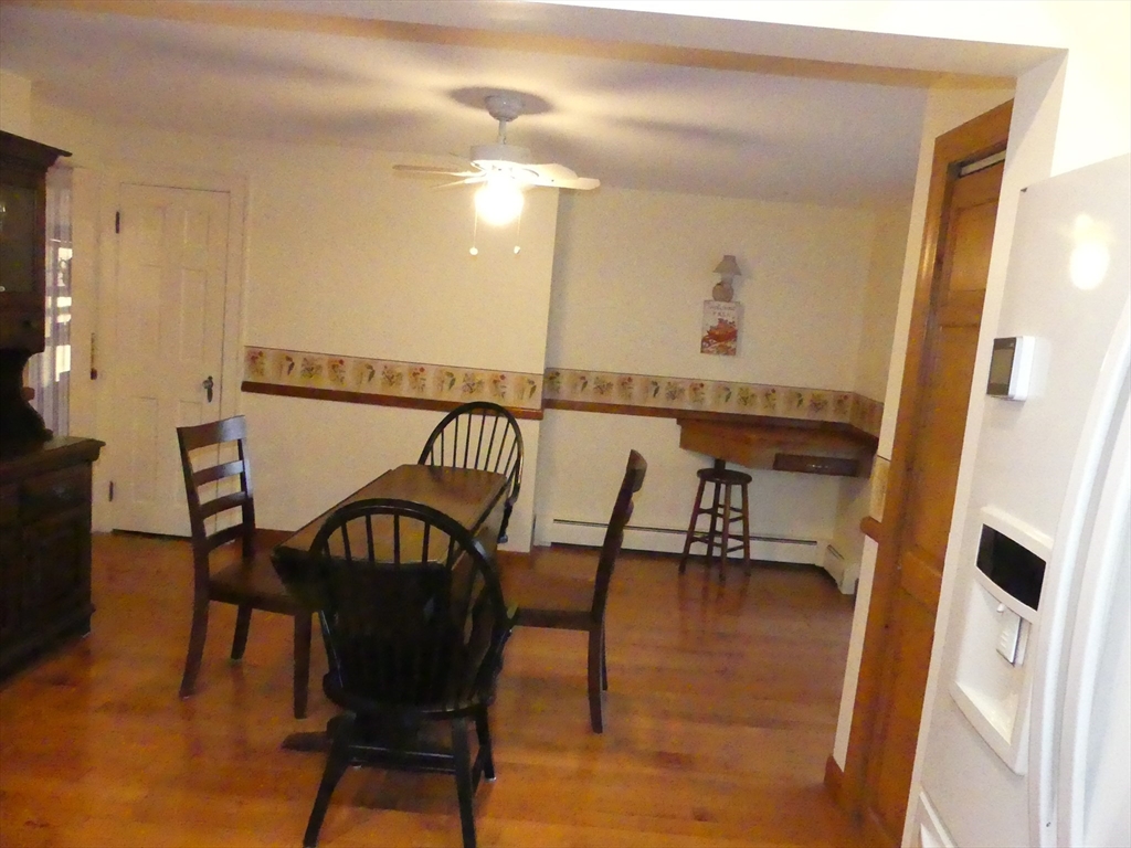 52 Ellsworth Avenue Beverly, MA 01915 - Photo 9 of 24 a view of a dining room with furniture and wooden floor