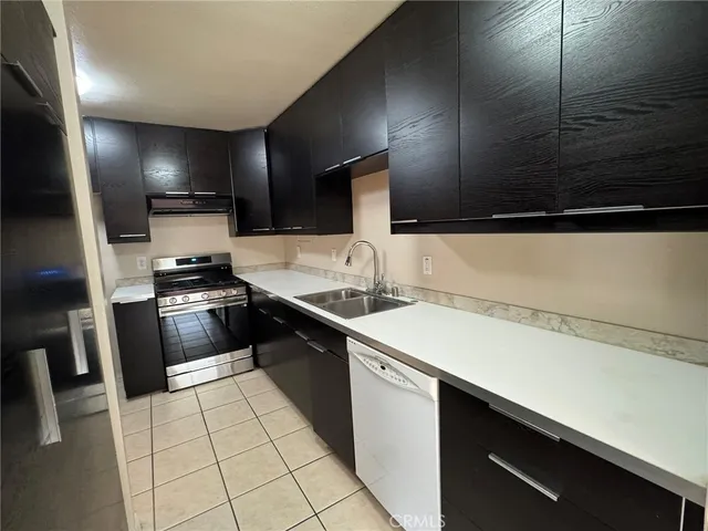 a kitchen with a sink a stove and cabinets