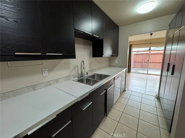 a kitchen with a sink and a refrigerator