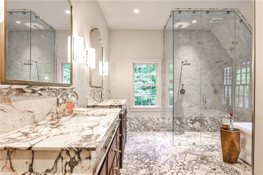 3990 Paces Ferry Road Northwest Atlanta, GA 30327 - Photo 28 of 63 a bathroom with a granite countertop sink a mirror and shower