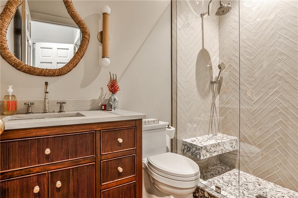 3990 Paces Ferry Road Northwest Atlanta, GA 30327 - Photo 33 of 63 a bathroom with a granite countertop toilet sink and mirror