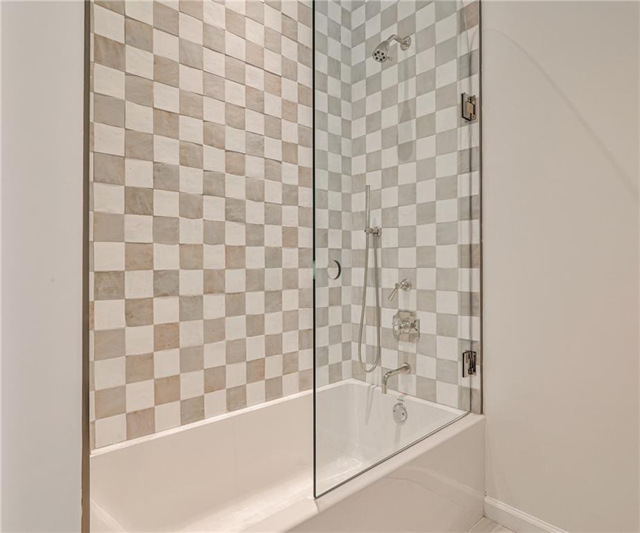 3990 Paces Ferry Road Northwest Atlanta, GA 30327 - Photo 40 of 63 a bathroom with a bathtub and a shower