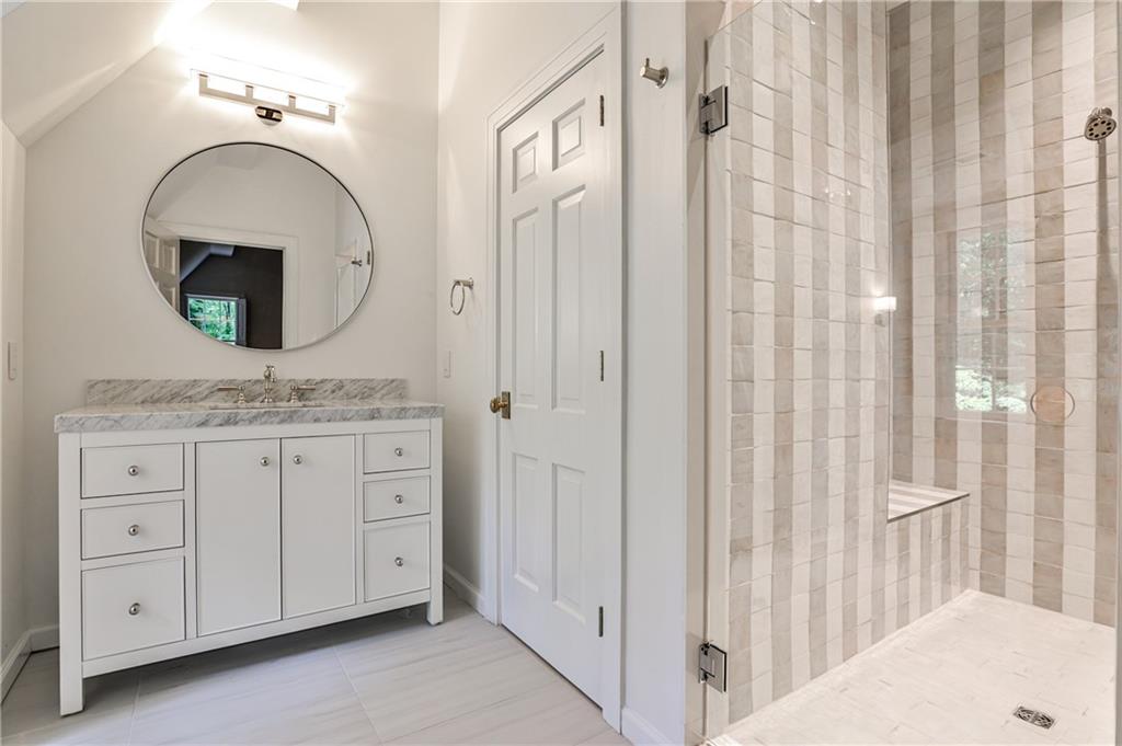 3990 Paces Ferry Road Northwest Atlanta, GA 30327 - Photo 42 of 63 a bathroom with a granite countertop sink and a mirror