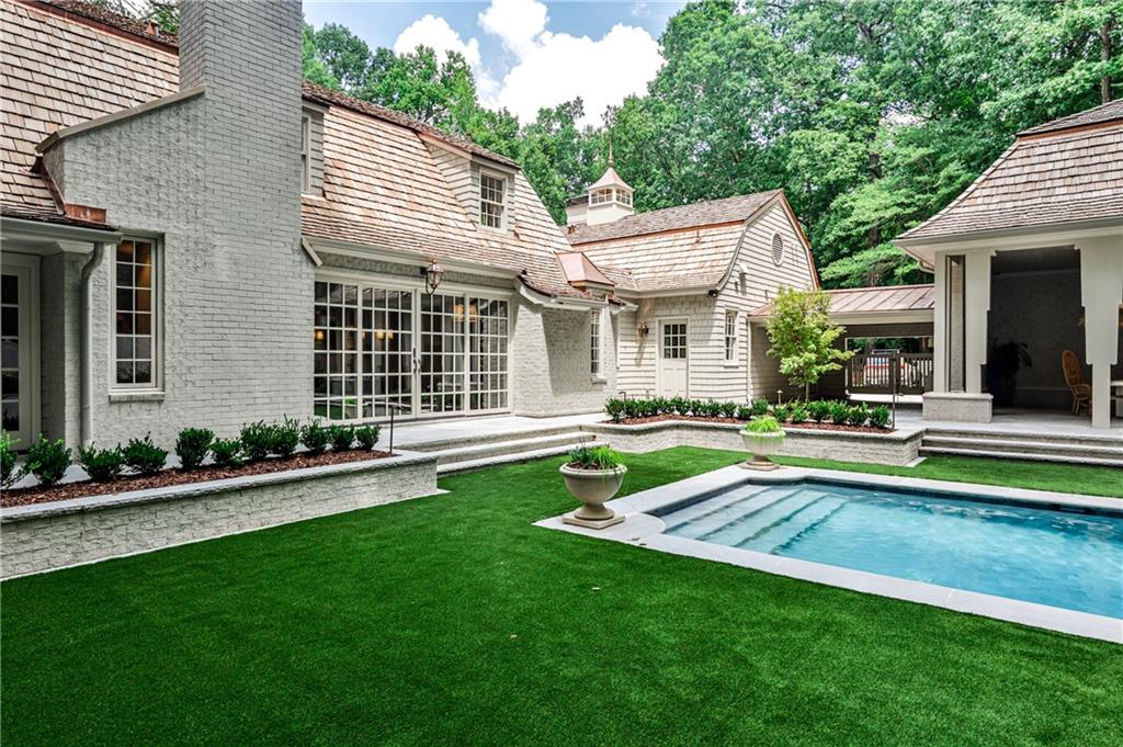 3990 Paces Ferry Road Northwest Atlanta, GA 30327 - Photo 56 of 63 a view of a house with a yard patio and swimming pool