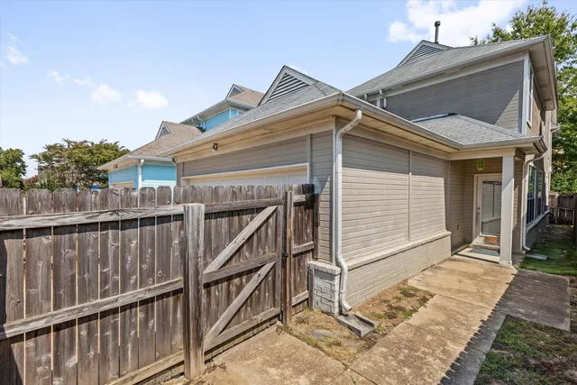 a view of a house with wooden fence