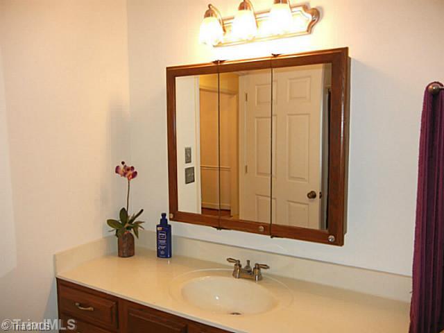 1411 Chesterfield Road Lewisville, NC 27023 - Photo 11 of 16 Bath. Spacious hall bath has neutral decor, large vanity, tub shower combination and the laundry area.