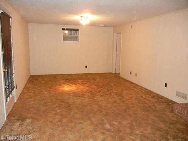 1411 Chesterfield Road Lewisville, NC 27023 - Photo 13 of 16 Playroom. Large lower level playroom has a walk out door to the fenced yard.