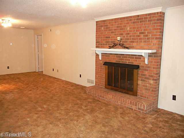 1411 Chesterfield Road Lewisville, NC 27023 - Photo 14 of 16 Playroom. Another view of the playroom showing the brick FP with gas logs.