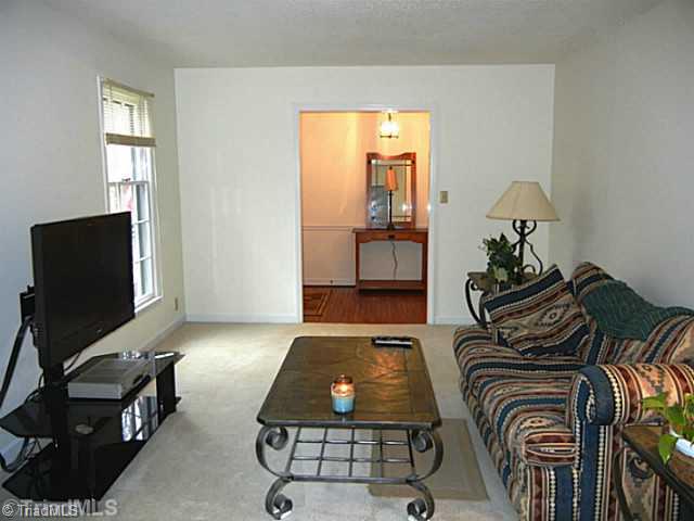 1411 Chesterfield Road Lewisville, NC 27023 - Photo 6 of 16 Living Room. Spacious bright living room open to the foyer to relax and look at the pretty front yard landscaping. Neutral decor throughout.