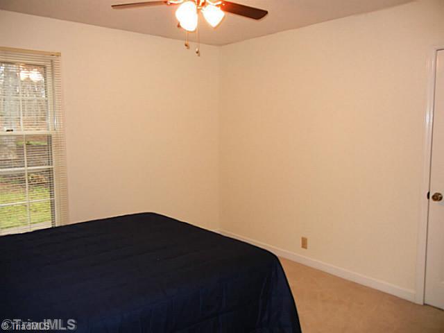 1411 Chesterfield Road Lewisville, NC 27023 - Photo 10 of 16 2nd Bedroom. Main level second bedroom has a ceiling fan, carpeting and mini blinds. There is a large linen closet in this hallway also.
