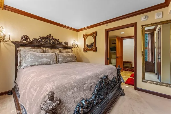 a bedroom with a bed and a painting on the wall