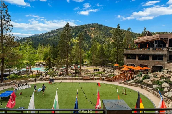 a view of a swimming pool with a patio and a yard