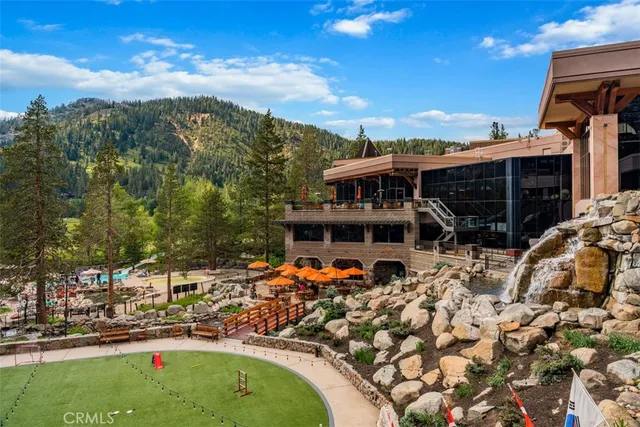a view of a swimming pool with a patio and a yard