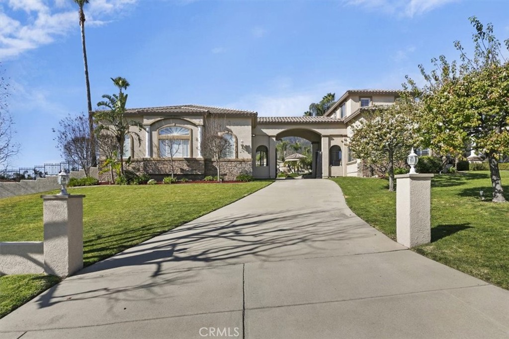 5030 Calypso Court Rancho Cucamonga, CA 91737 - Photo 11 of 74 a front view of a house with garden