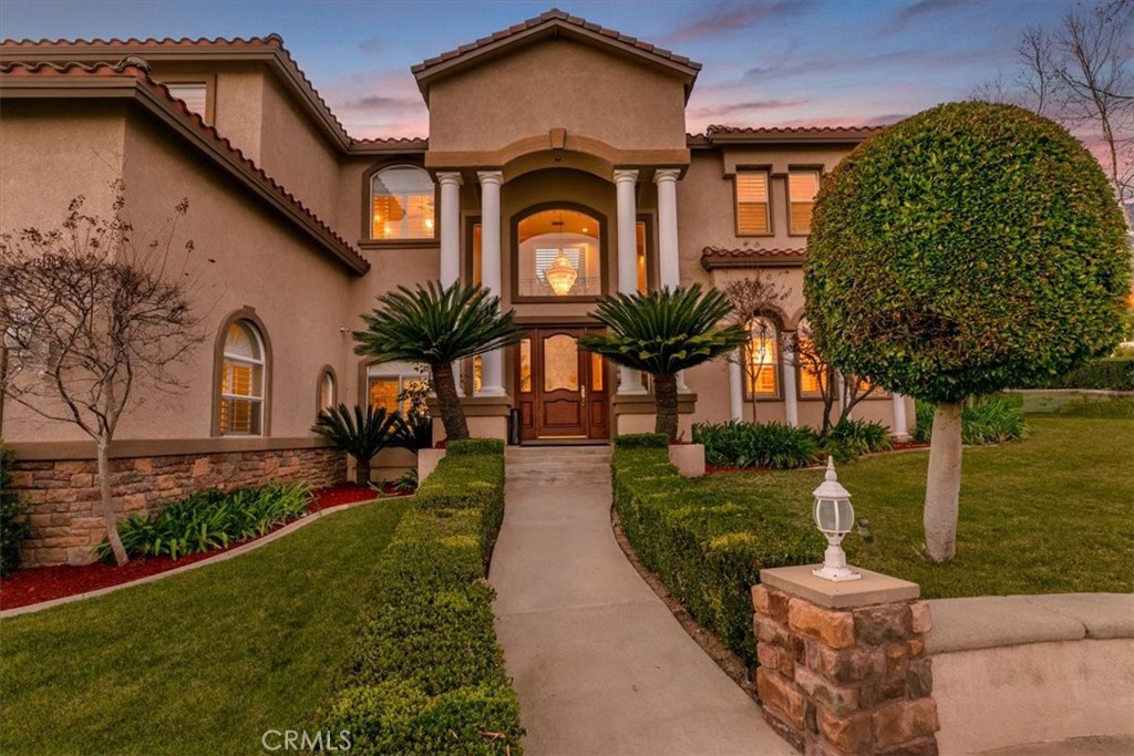 5030 Calypso Court Rancho Cucamonga, CA 91737 - Photo 14 of 74 a front view of a house with garden