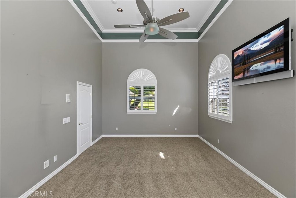 5030 Calypso Court Rancho Cucamonga, CA 91737 - Photo 22 of 74 an empty room with windows and fan