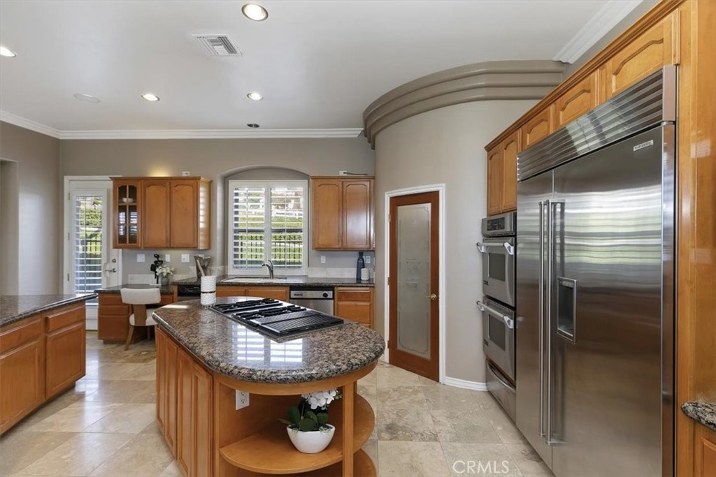 5030 Calypso Court Rancho Cucamonga, CA 91737 - Photo 26 of 74 a kitchen with sink refrigerator and window