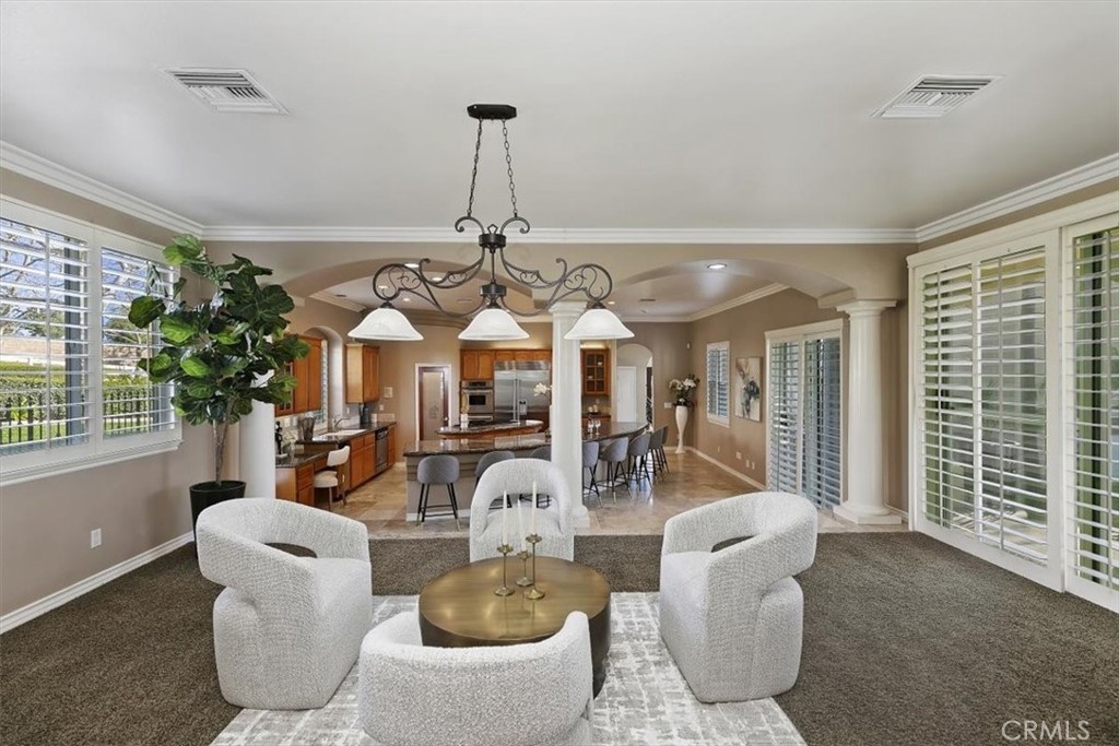 5030 Calypso Court Rancho Cucamonga, CA 91737 - Photo 28 of 74 a living room with furniture a chandelier and a window