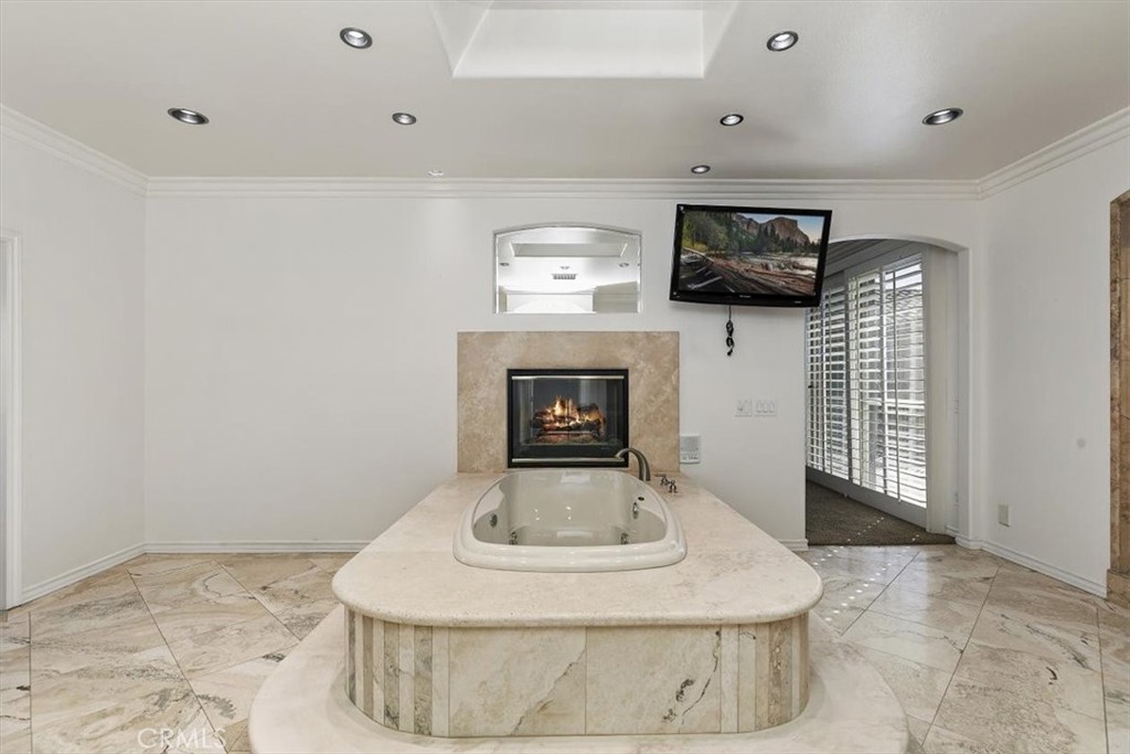 5030 Calypso Court Rancho Cucamonga, CA 91737 - Photo 40 of 74 a room with fireplace and flat screen tv