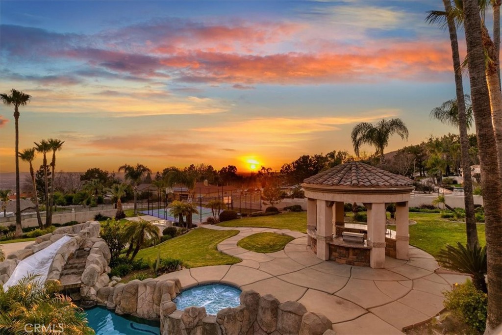 5030 Calypso Court Rancho Cucamonga, CA 91737 - Photo 61 of 74 a view of a swimming pool with lawn chairs and a potted plant