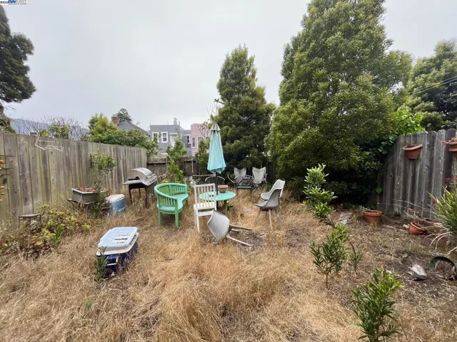 a view of a backyard with plants and outdoor seating
