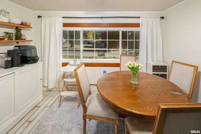 a dining room with furniture and wooden floor