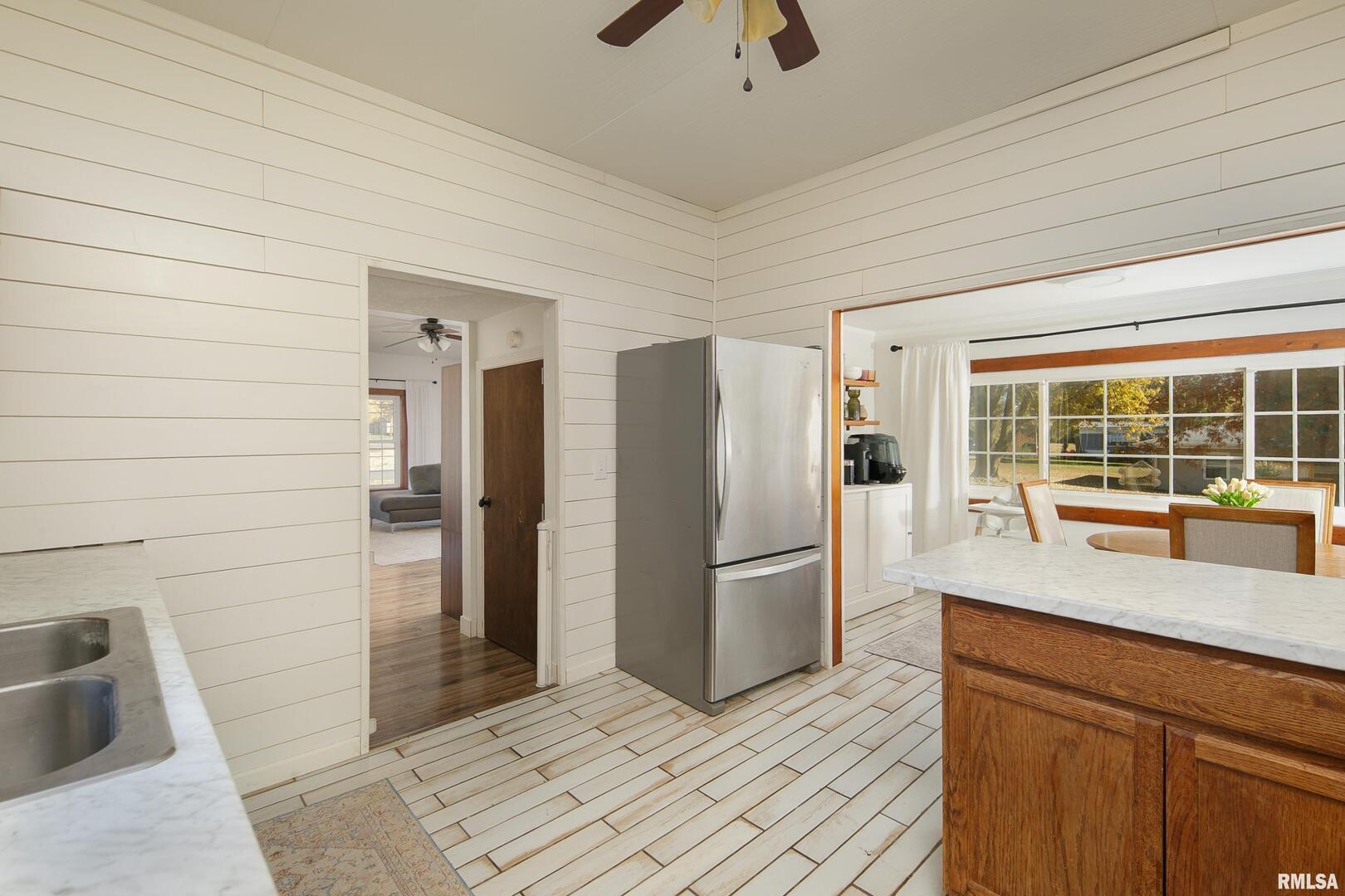 401 3rd Street Matherville, IL 61263 - Photo 17 of 32 a kitchen with stainless steel appliances granite countertop a refrigerator and a sink